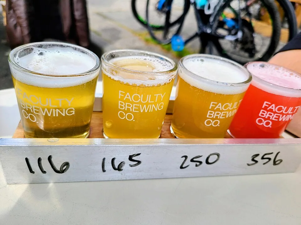 Small tasting glasses arranged in a craft beer flight, illustrative photograph