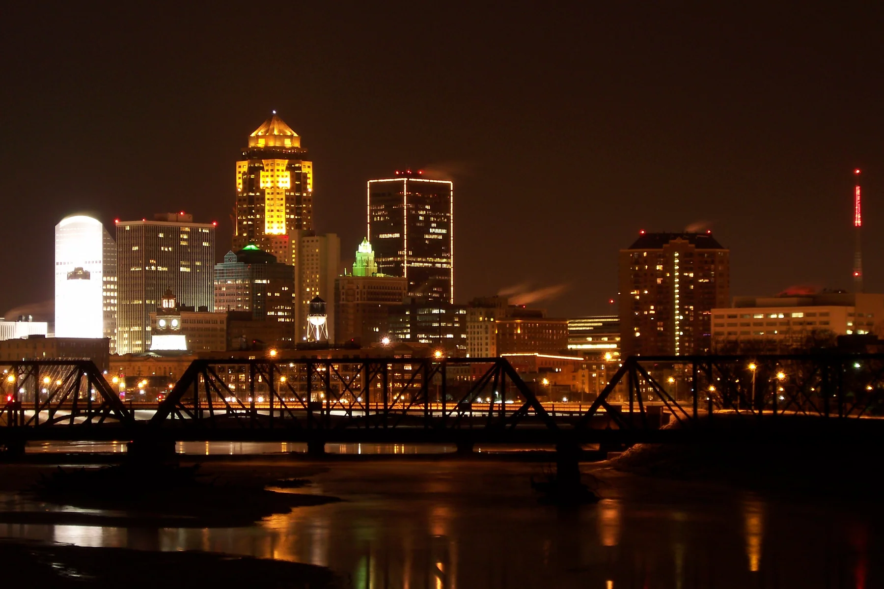 Illuminated downtown Des Moines skyline and bridge at night