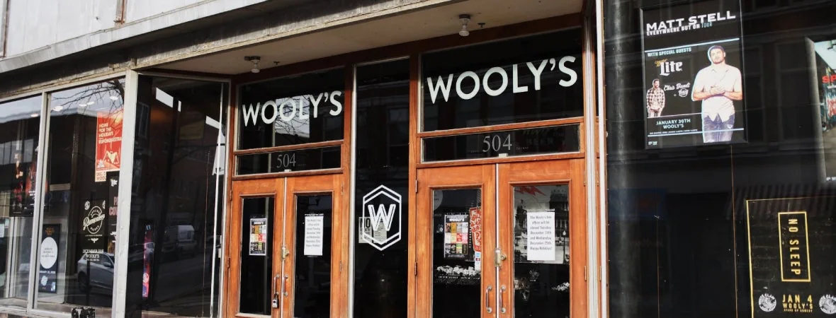 Wooly’s glass entrance doors marked 504 East Locust Street